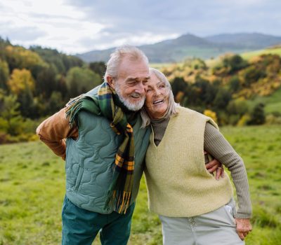 happy-senior-couple-walking-in-autumn-meadow-2022-10-25-21-40-52-utc